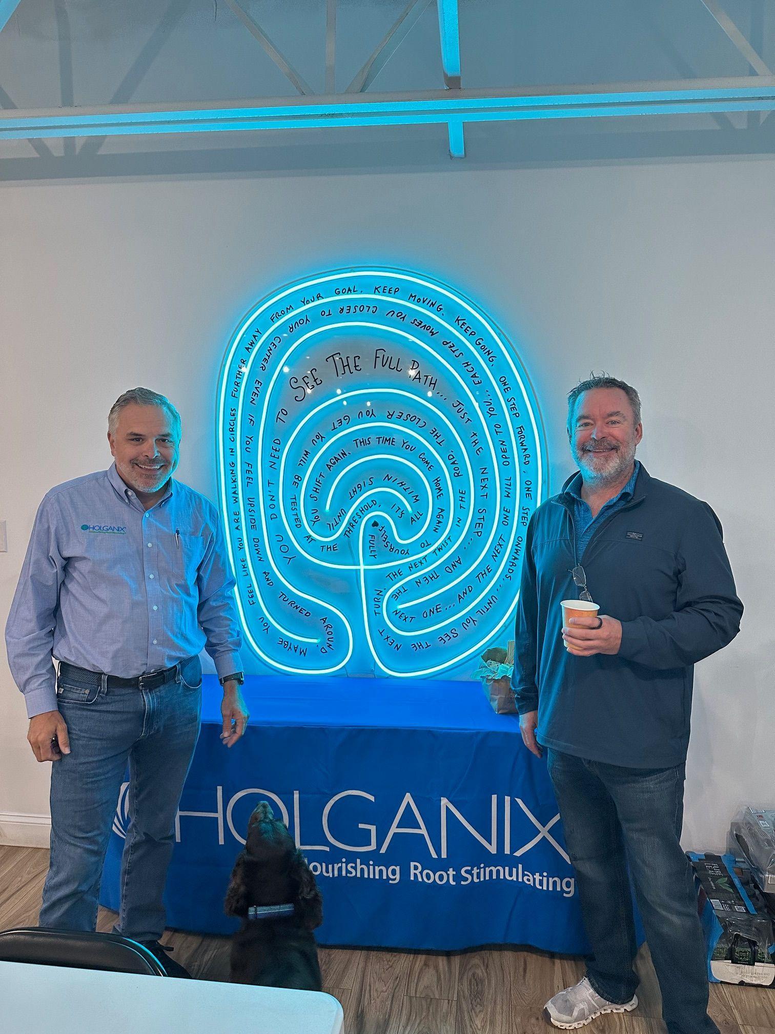The Holganix team with the neon Living Labyrinth in their space