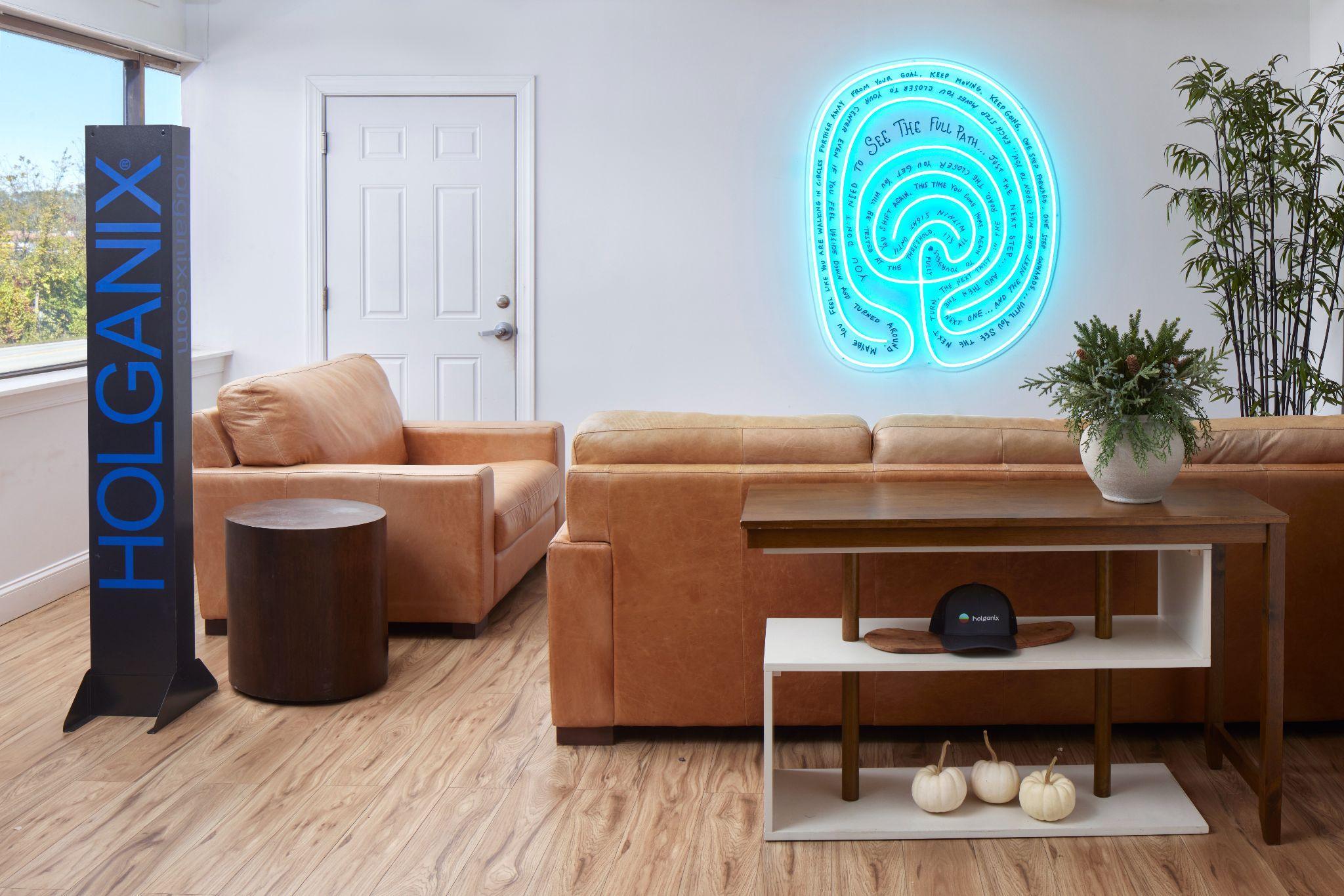 The neon Living Labyrinth glowing in a lounge